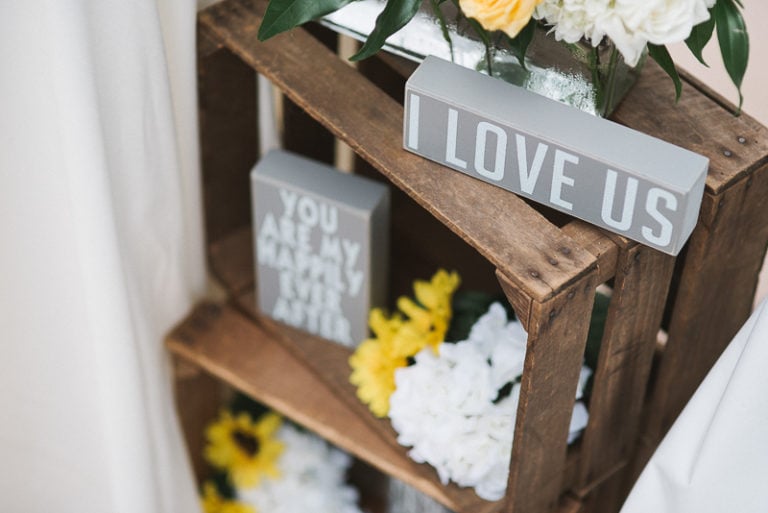 Apple boxes filled with sunflowers and love notes at ceremony